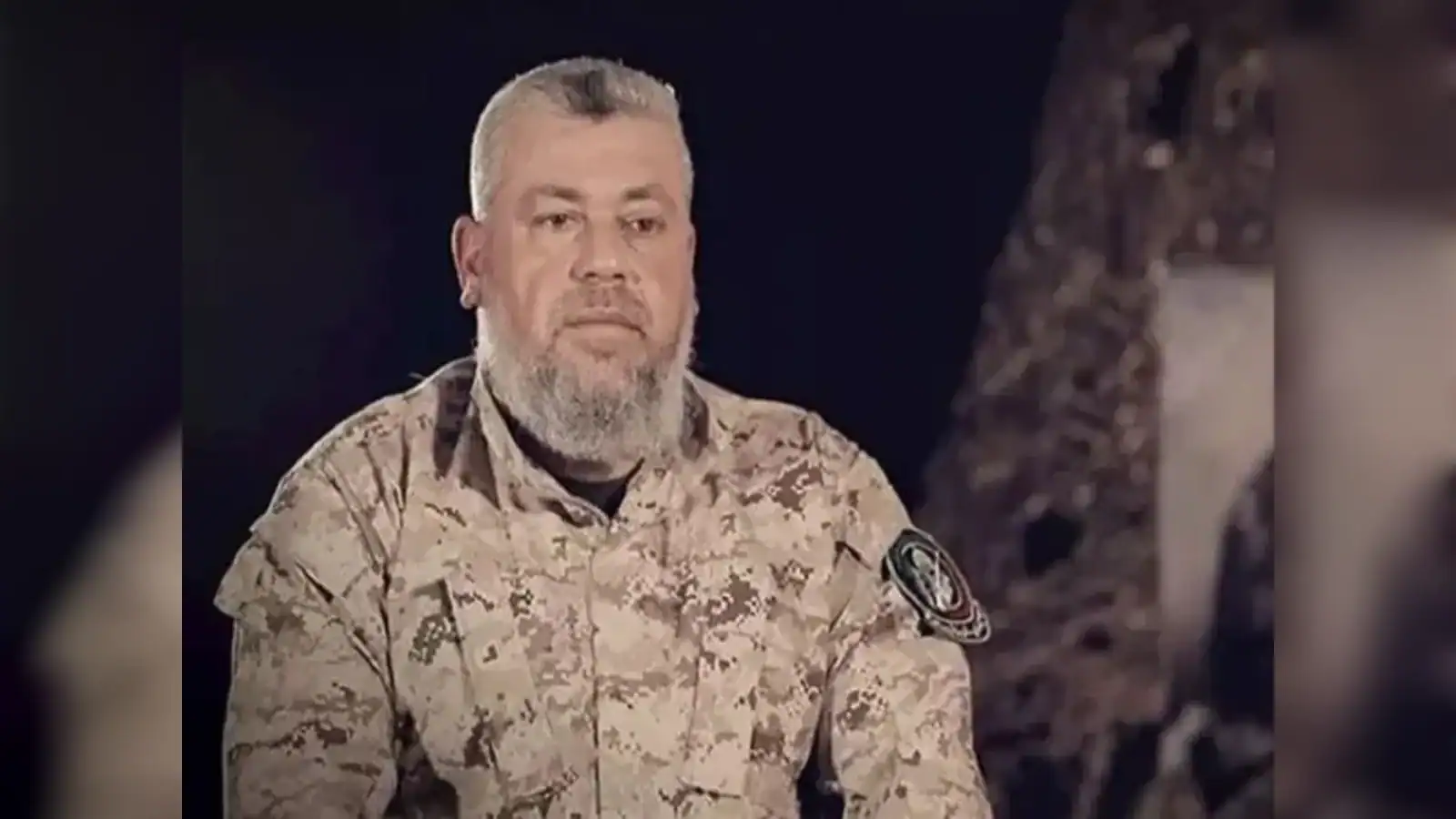 Hamas commander Izz al-Din al-Haddad wearing military uniform during a recorded appearance.