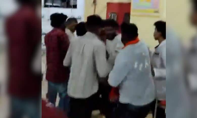 School students listening to a teacher during a classroom activity.
