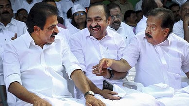 Congress leaders smiling and engaging at a political meeting in Kerala.