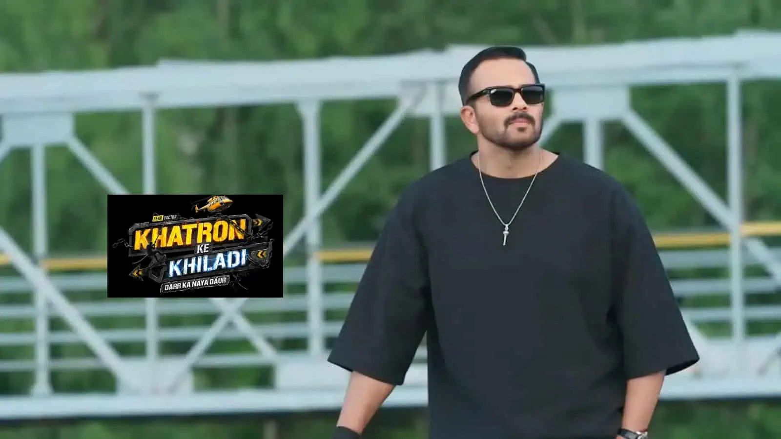 A man with sunglasses and a black outfit standing outdoors, promoting Khatron Ke Khiladi 15 TV show.