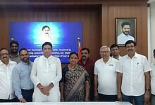 Group of diverse professionals and leaders standing together in a formal setting with a portrait of a pro.