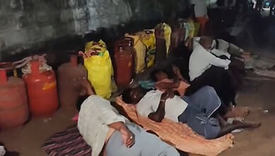 Villagers sleep on the street outside a gas agency in Mahabubabad due to gas supply issues despite bookin.