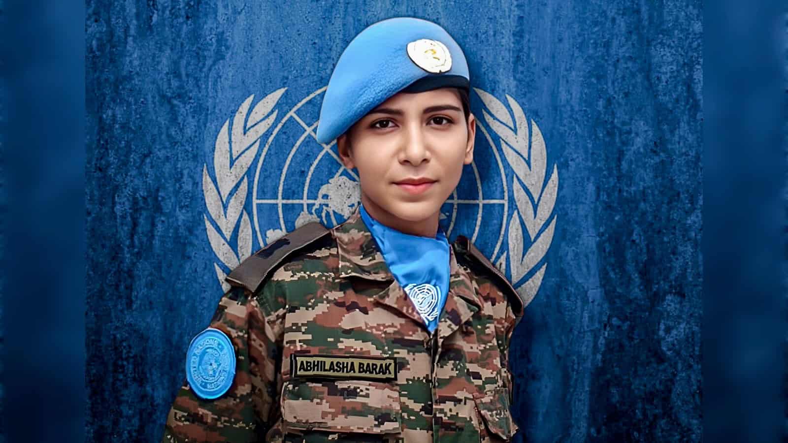 Young female UN peacekeeper in uniform with blue beret and UN insignia, standing confidently in front of.