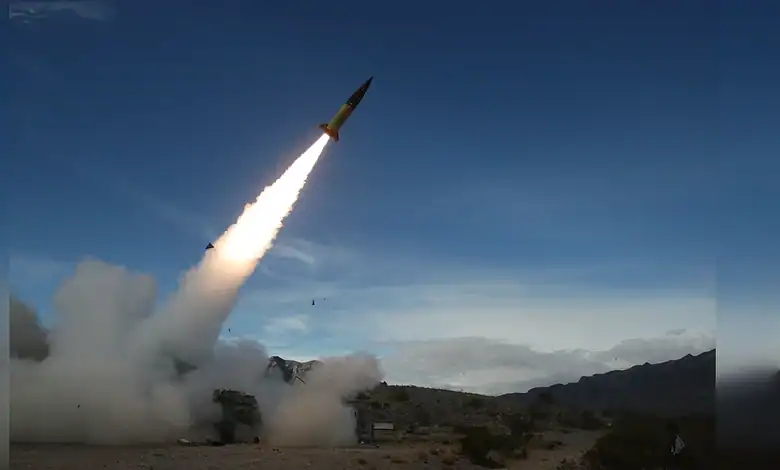 Missile launch during military exercise in desert landscape.