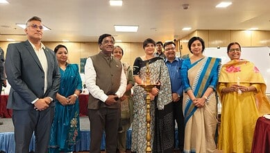 Group of officials and women at a formal event promoting nursing employment opportunities in Germany.