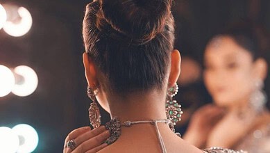 Elegant woman with traditional jewellery, showcasing cultural attire and accessories at a festive event o.