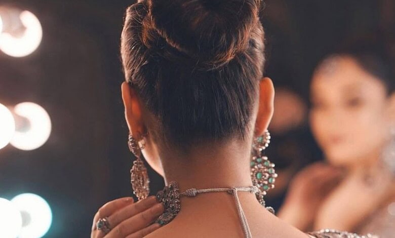 Elegant woman with traditional jewellery, showcasing cultural attire and accessories at a festive event o.