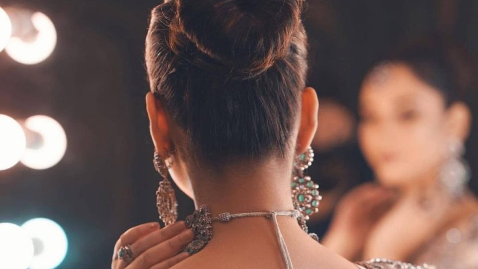 Elegant woman with traditional jewellery, showcasing cultural attire and accessories at a festive event o.