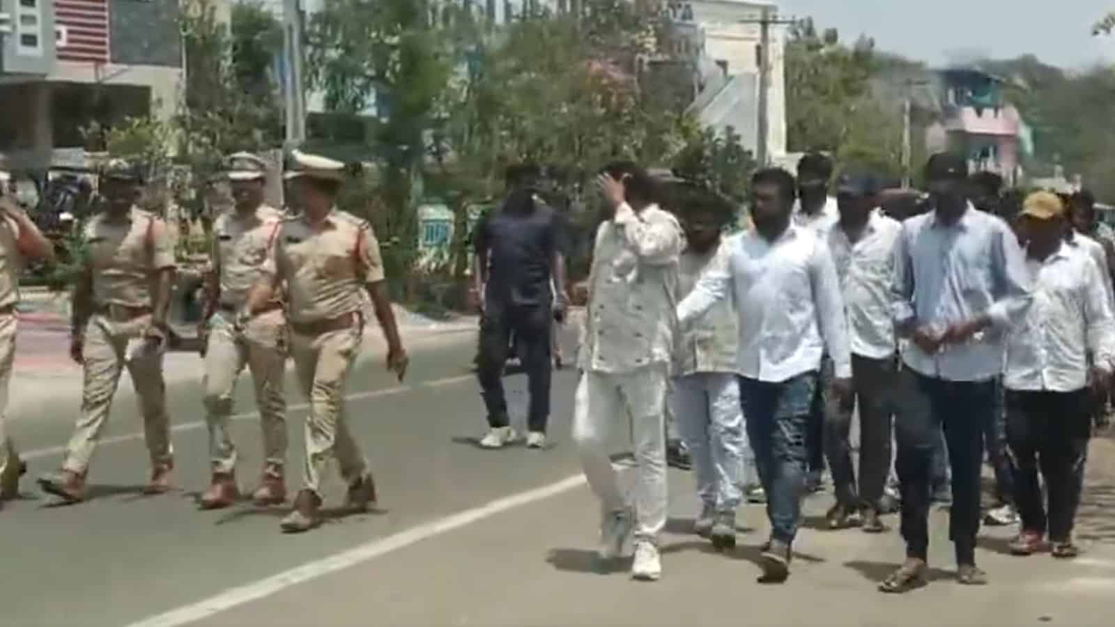 Protesters walking on the street with police officers present, demonstrating public unrest and law enforc.