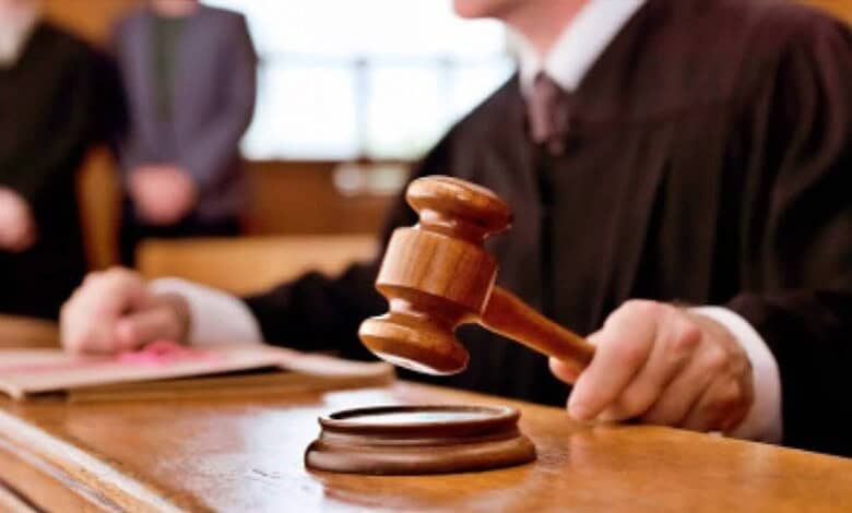 Gavel being used in a courtroom for legal proceedings and justice delivery.
