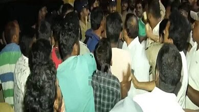 A crowded group of people gathered closely together at an indoor event.