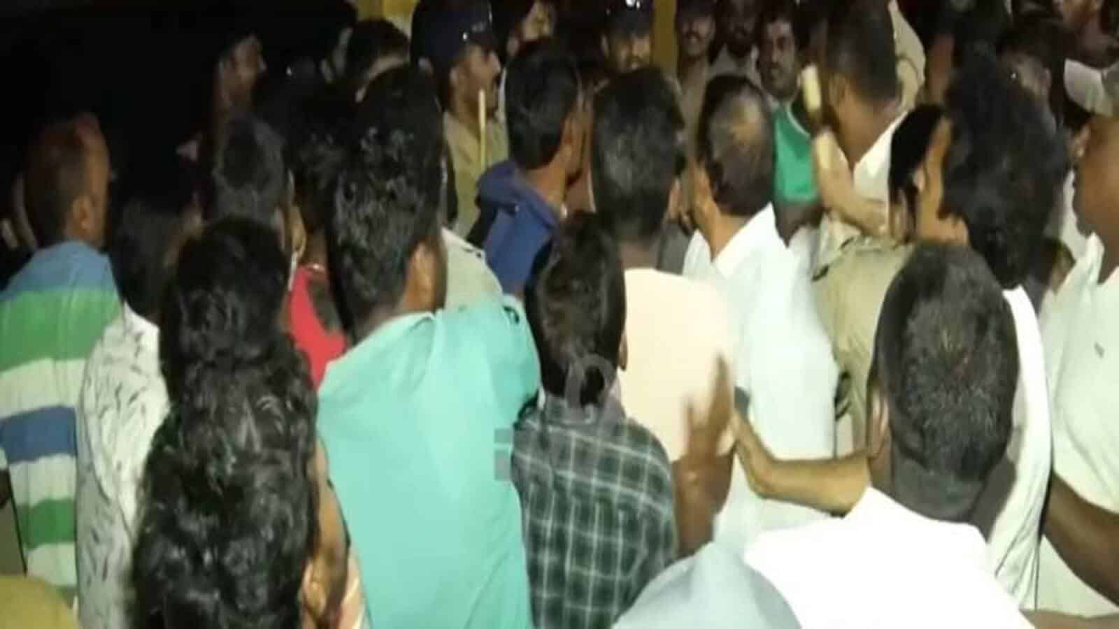 A crowded group of people gathered closely together at an indoor event.