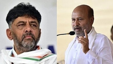 Indian politician speaking passionately at a public event, wearing white traditional attire and gesturing.