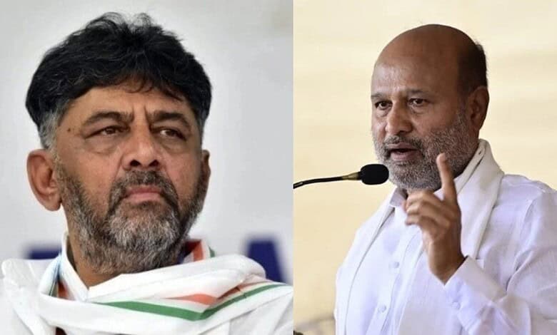 Indian politician speaking passionately at a public event, wearing white traditional attire and gesturing.