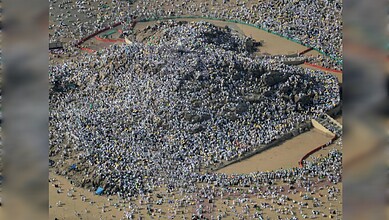 Aerial view of a large crowd assembled in an open area, with many people participating in a public gather.