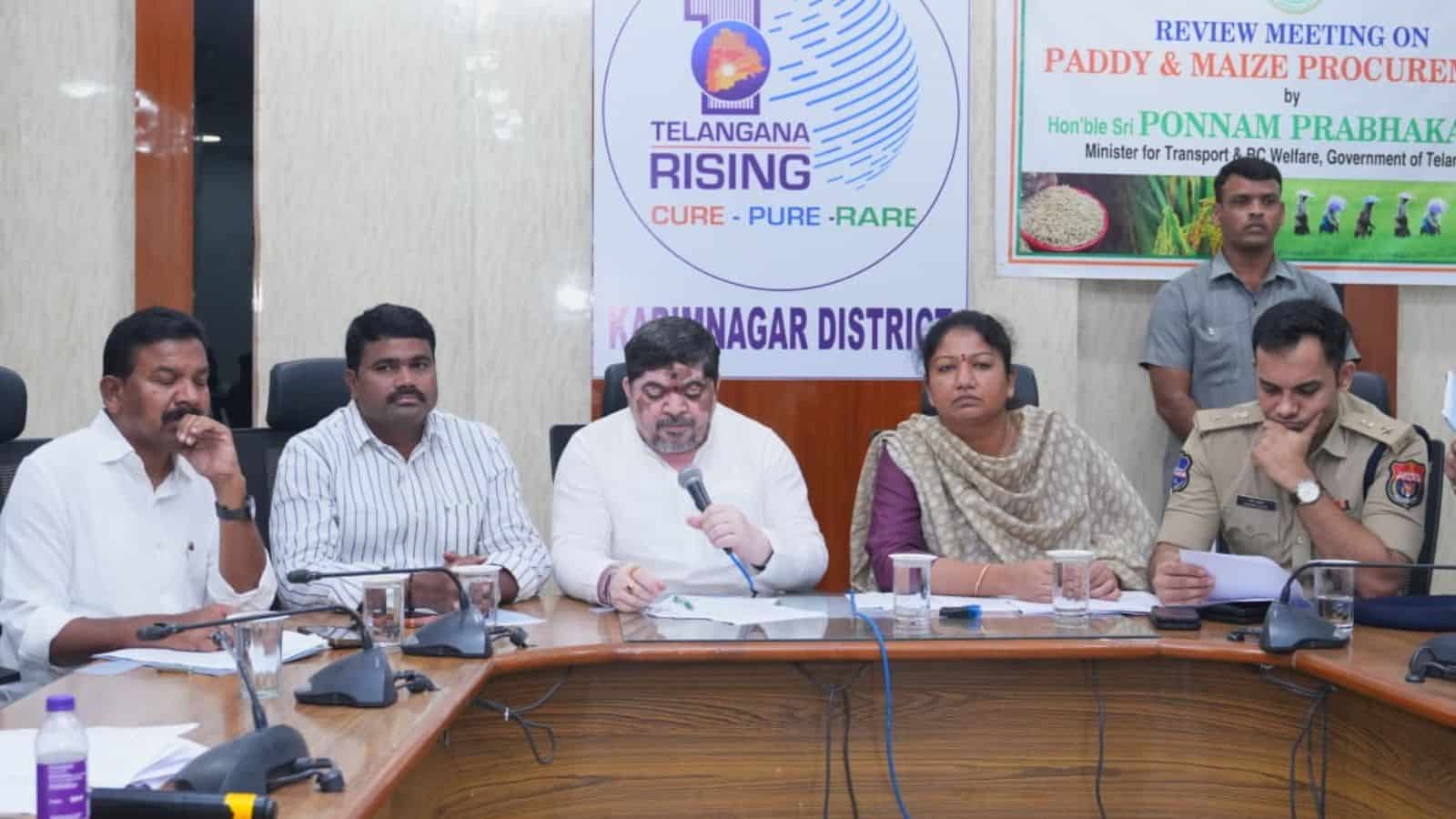 Enhanced image of officials at a meeting discussing Telangana Rising initiatives, with banners in the bac.