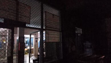 Night view of Siasat Daily office entrance with illuminated interior and exterior lighting, behind a meta.
