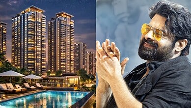 Luxury high-rise apartment buildings at night with illuminated windows and a swimming pool in the foregro.