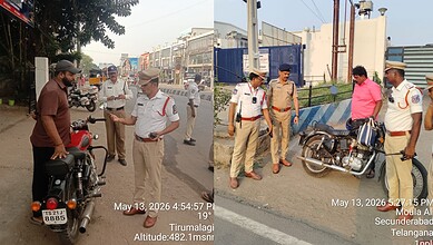 Motorcycle police officers interacting with civilians on a busy street in Tirumalagiri, Hyderabad, India.