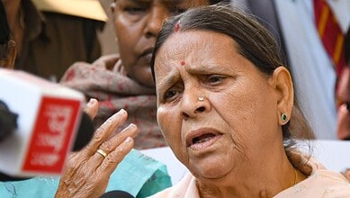 A woman speaking passionately during a public event or protest, surrounded by attentive individuals.