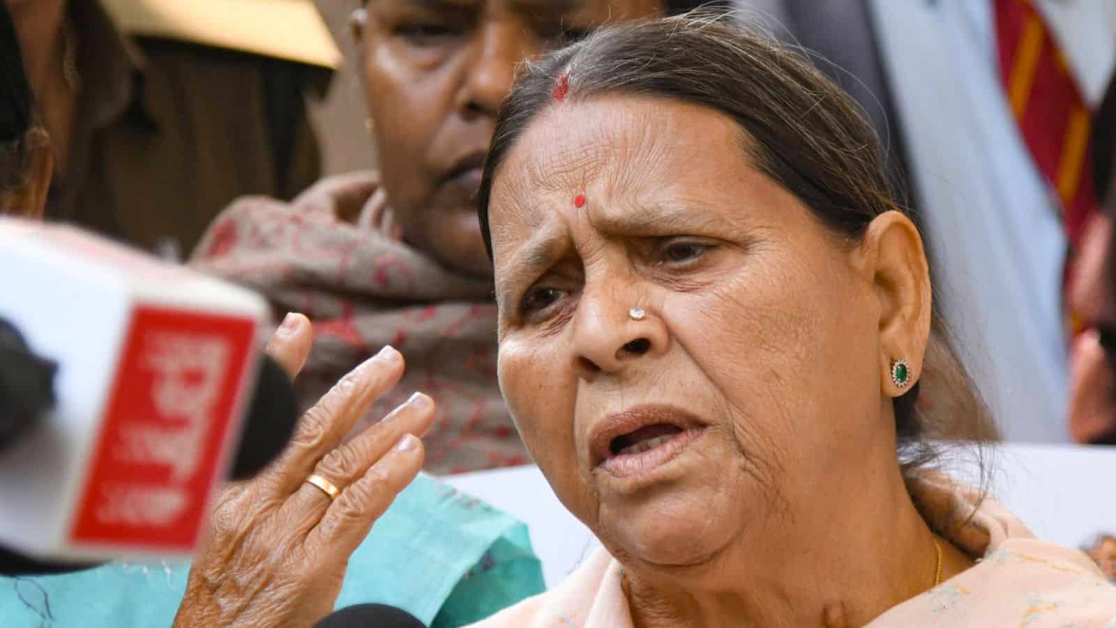 A woman speaking passionately during a public event or protest, surrounded by attentive individuals.