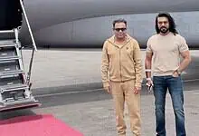 Aviation professionals standing beside a private jet on the tarmac.