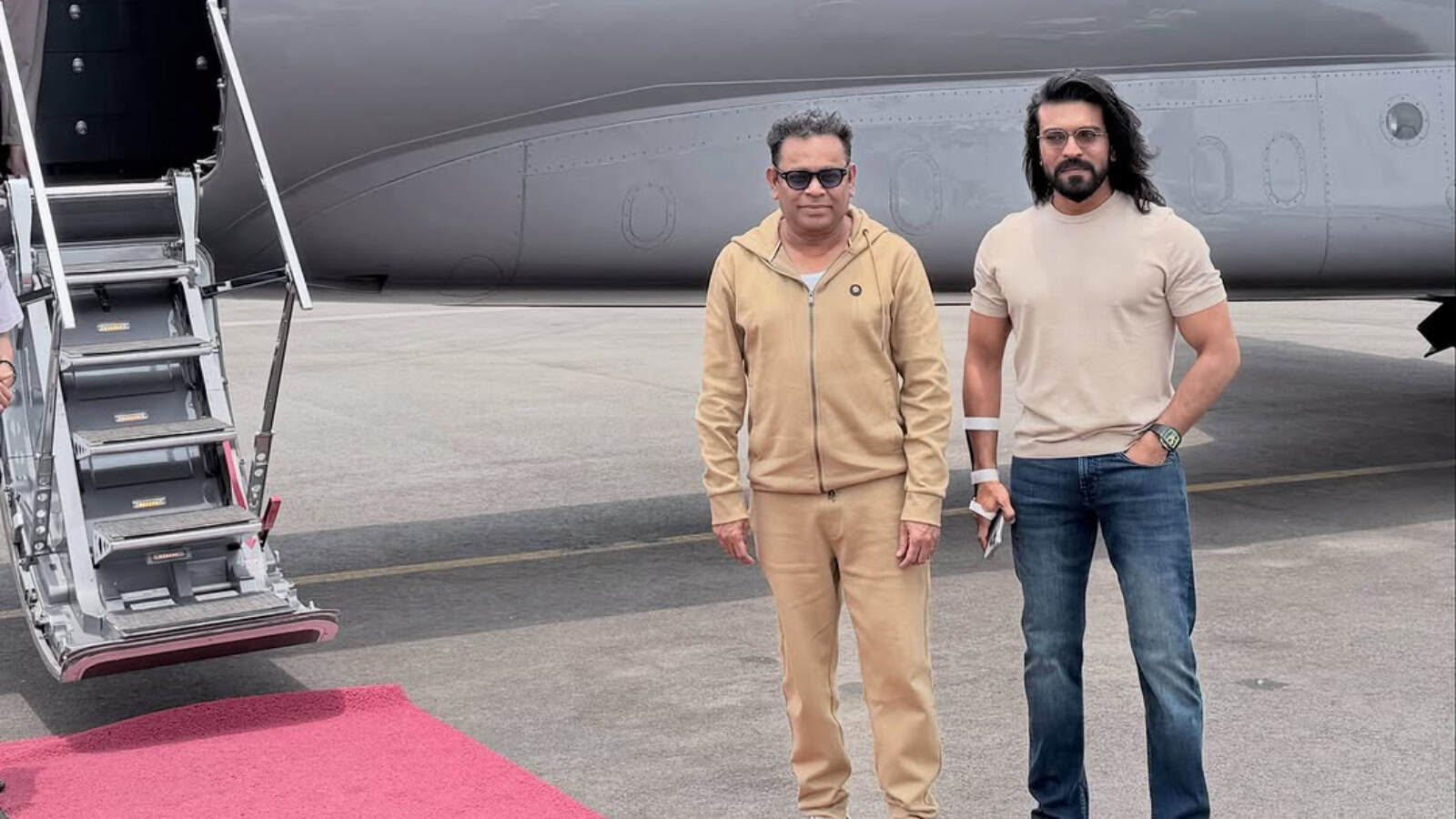 Aviation professionals standing beside a private jet on the tarmac.