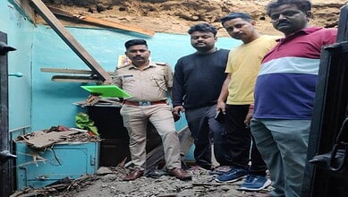 Community members inspecting flood damage near a water body.