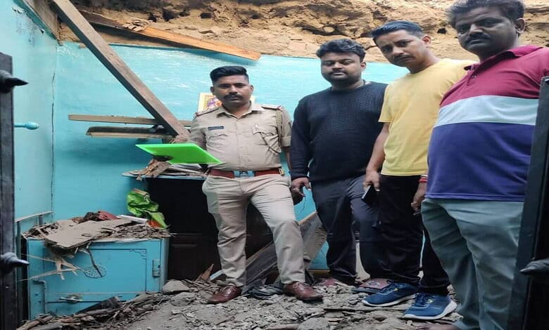 Community members inspecting flood damage near a water body.