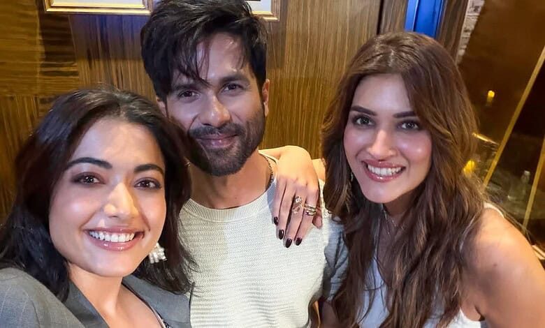 A smiling group of three friends taking a selfie indoors, showcasing friendship and happiness.