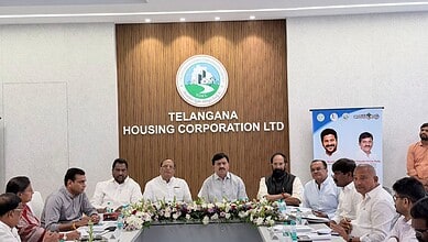 Officials at Telangana Housing Corporation LTD discuss land dispute resolutions.