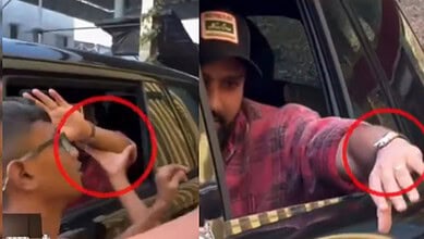A young boy attempting to snatch Rohit Sharma's Rs 3 crore watch from a car window.
