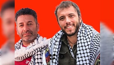 Two activists with Palestinian scarves detained by Israeli forces after Gaza aid flotilla interception.