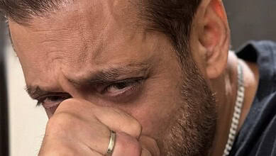 Salman Khan appears emotional, holding his face with a distressed expression during a public appearance.