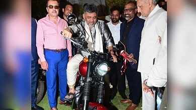 Motorcycle unveiling event with dignitaries and media presence.
