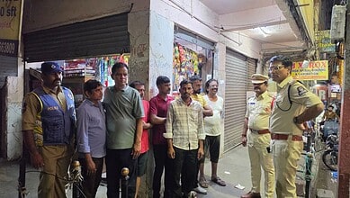 Police officers and civilians discussing during a crackdown on public smoking and drinking in Hyderabad.