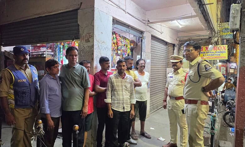 Police officers and civilians discussing during a crackdown on public smoking and drinking in Hyderabad.