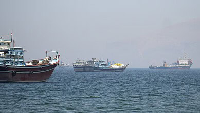 Boats and cargo vessels sail through the Strait of Hormuz near Musandam, Oman, on April 29, 2026.