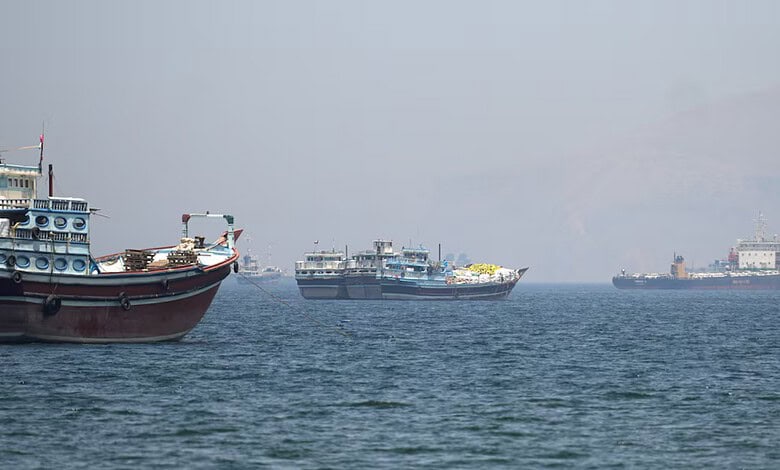 Boats and cargo vessels sail through the Strait of Hormuz near Musandam, Oman, on April 29, 2026.