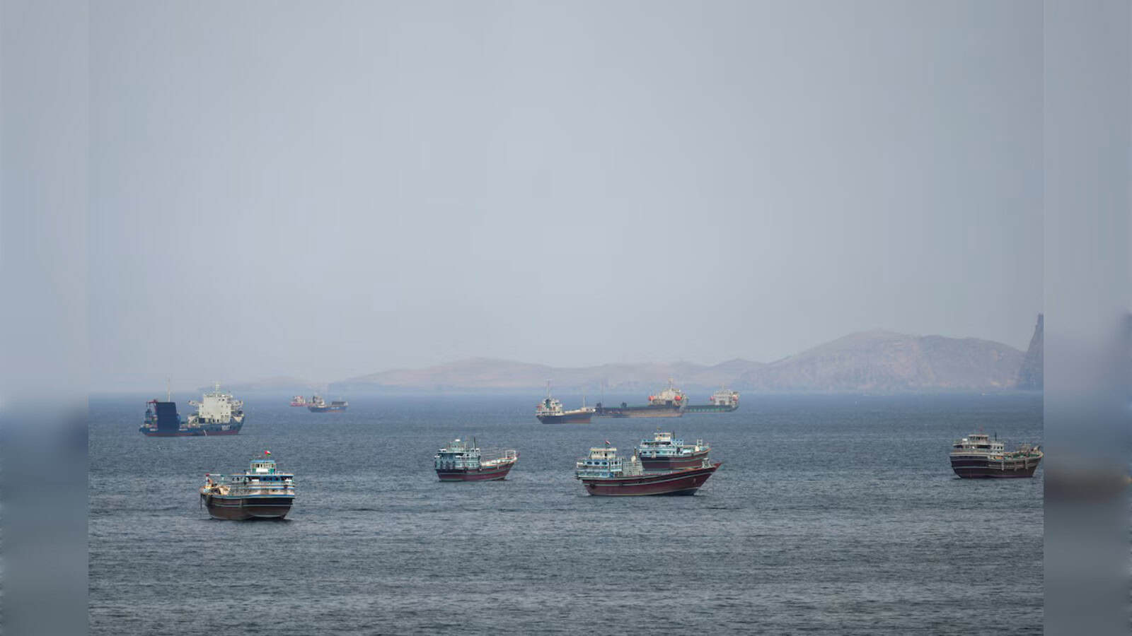 Oil tankers and ships in the Persian Gulf amid maritime tensions and regional conflicts.
