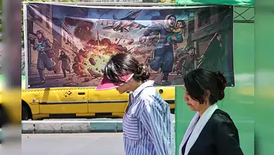 Explosion protest mural in urban street with two women observing, depicting chaos and conflict.