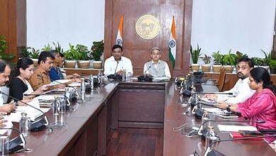 Officials and leaders discuss welfare schemes in Telangana during a government review meeting.