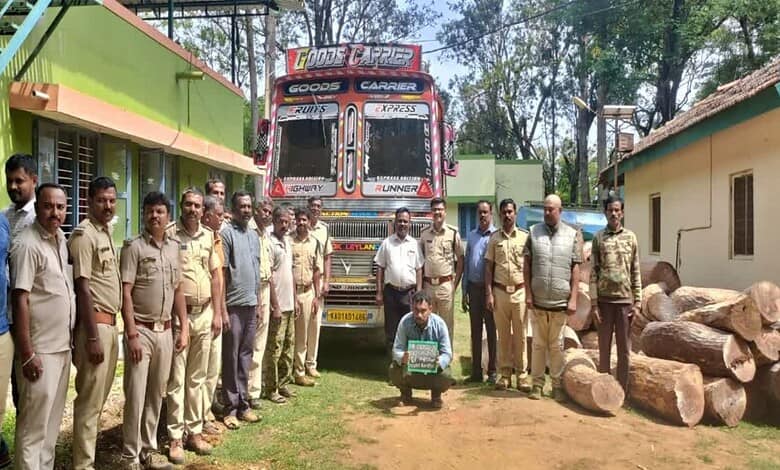 Truck convoy with personnel and logs in a rural setting, India.