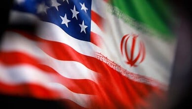 Flags of the USA and Iran flutter side by side, symbolising international relations and diplomatic ties.