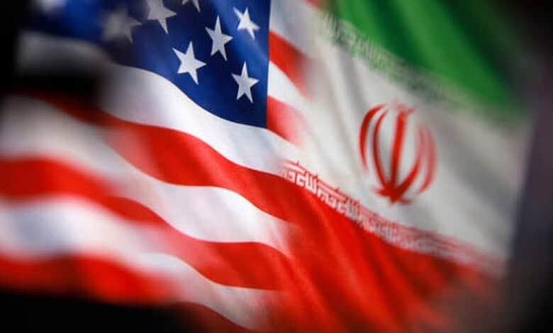Flags of the USA and Iran flutter side by side, symbolising international relations and diplomatic ties.