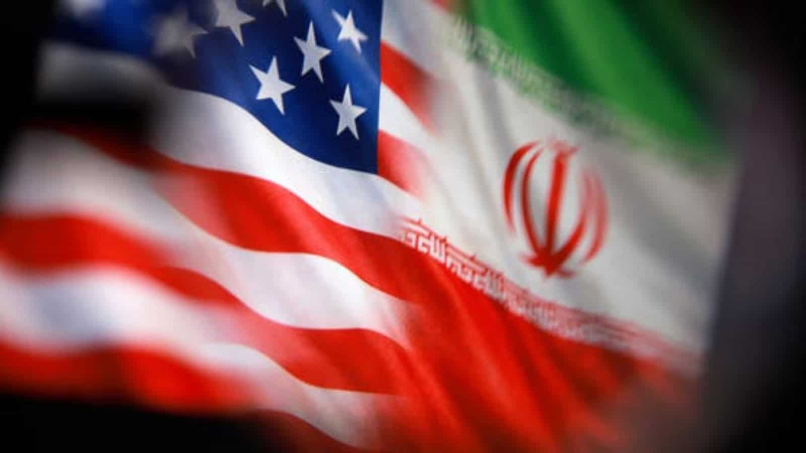 Flags of the USA and Iran flutter side by side, symbolising international relations and diplomatic ties.
