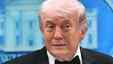 Donald Trump at a press event, delivering a speech in a professional environment.