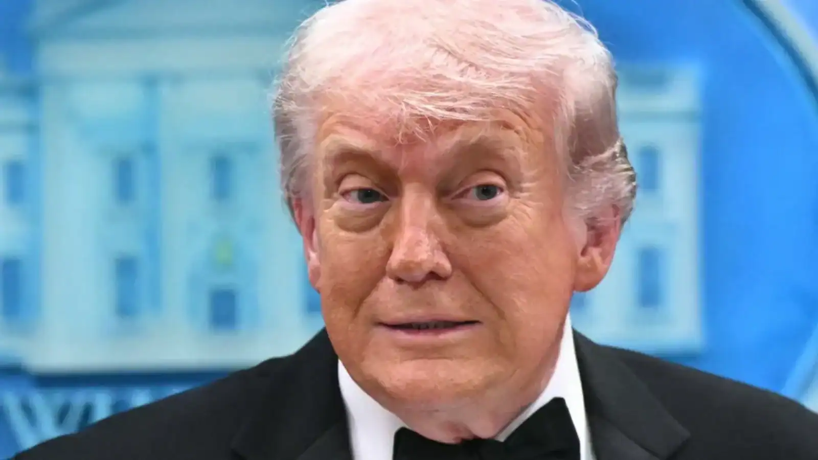 Donald Trump at a press event, delivering a speech in a professional environment.