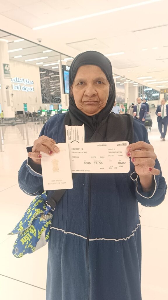 Veera Venkamma holds her passport and boarding pass at the airport before departing for India from Saudi Arabia.
