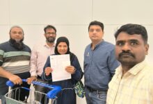Community members holding documents and a shopping cart in an indoor setting, representing social activis.